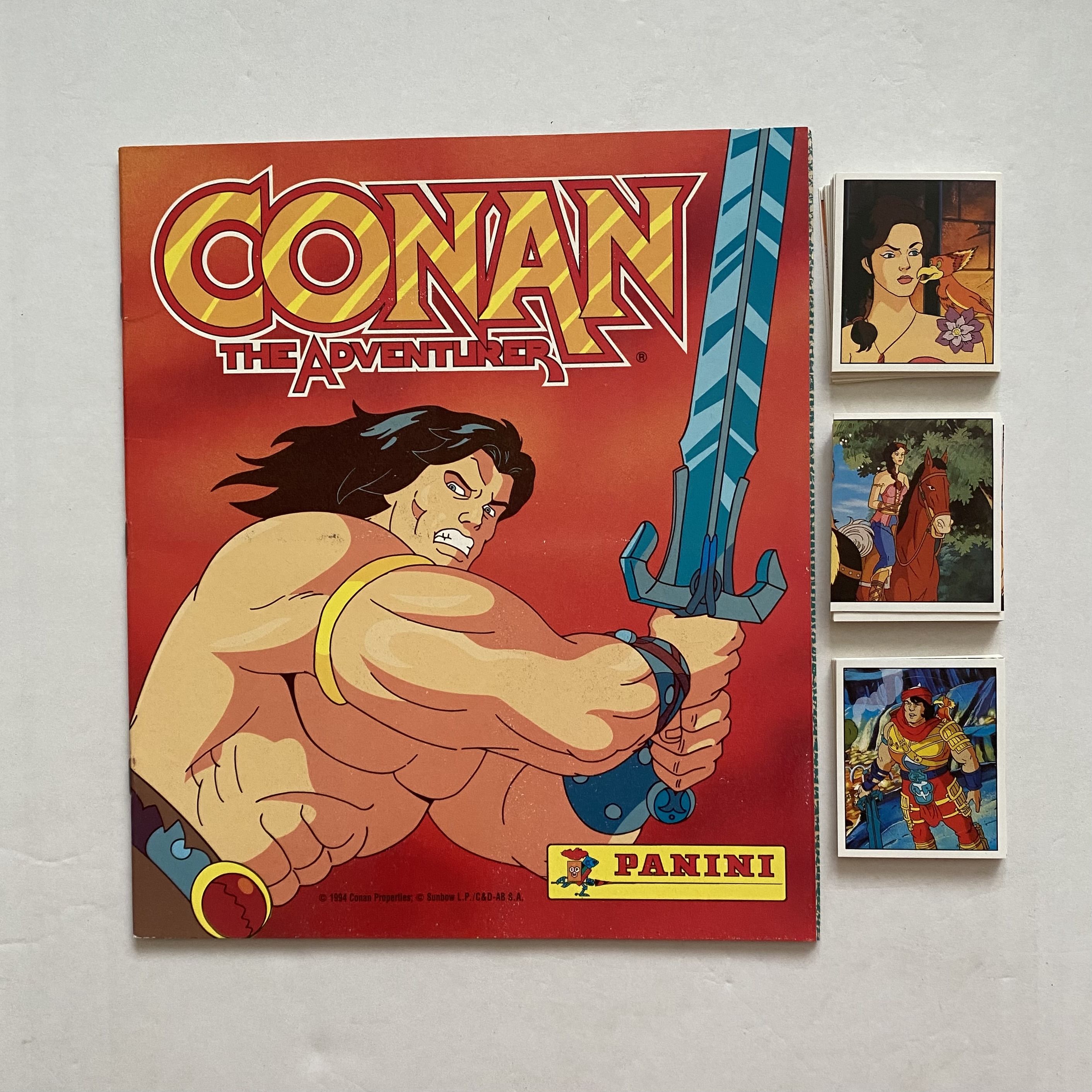 Альбом Приключения Конана-варвара (Conan) + 100 наклеек (Panini) / Язык альбома - Португальский