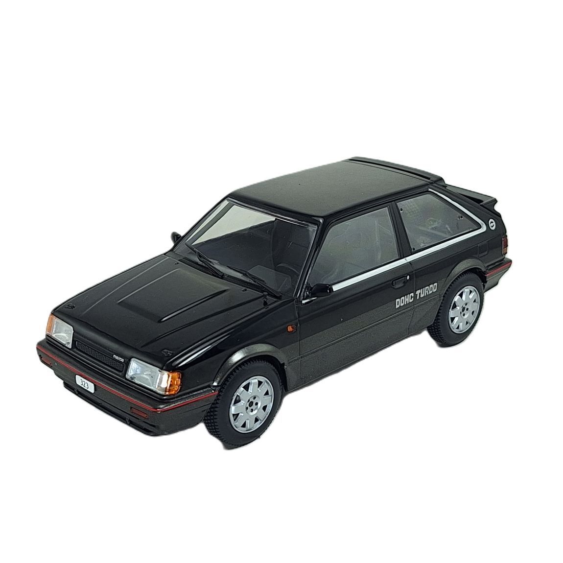 Коллекционная модель автомобиля WhiteBox MAZDA 323 4WD Turbo 1989 Black/Dark Grey