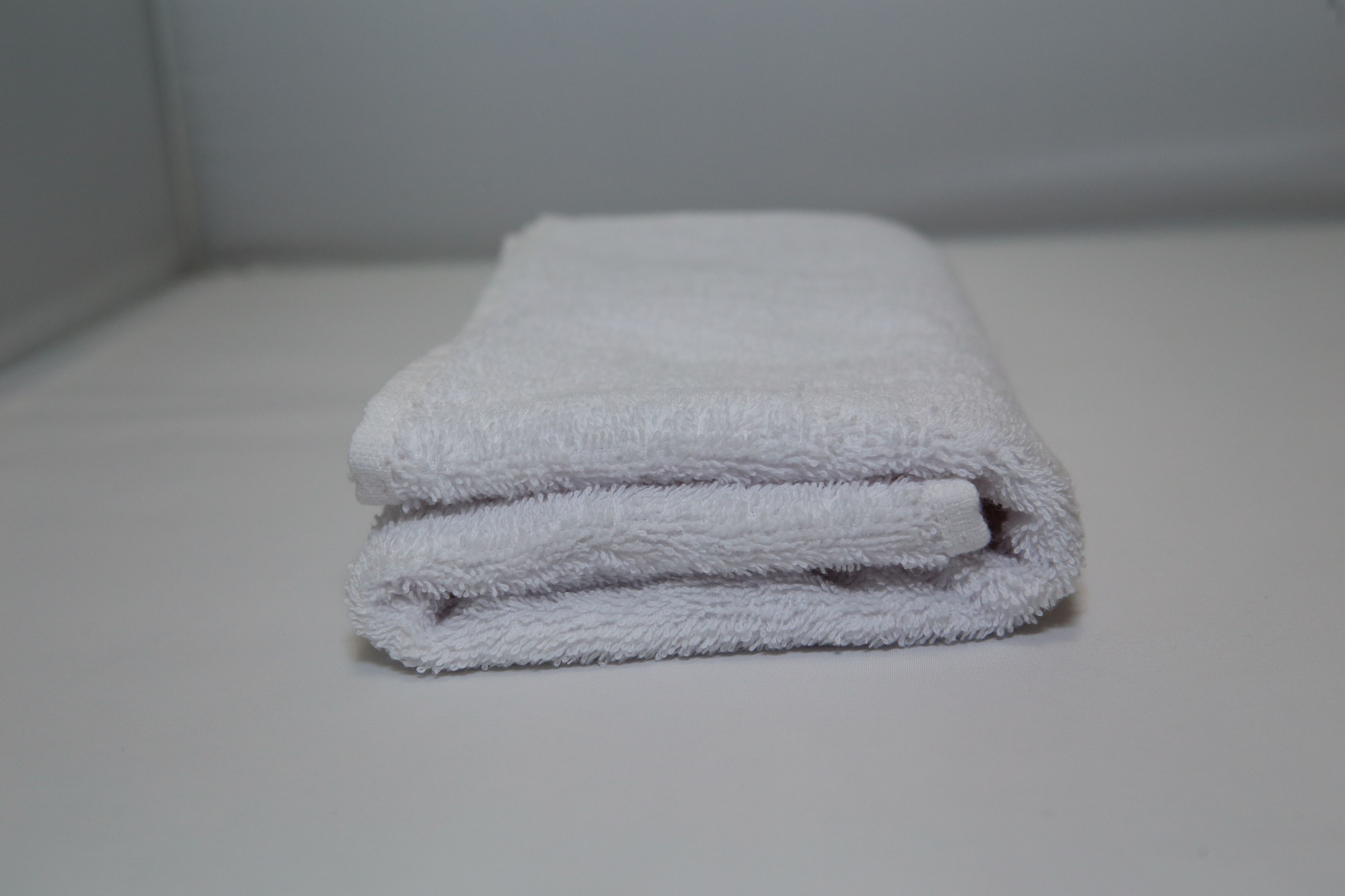Приснилось полотенце. Полотенце армейское. Старое дешевое полотенце. Серое полотенце из плюша. Белое махровое полотенце сложено краем.
